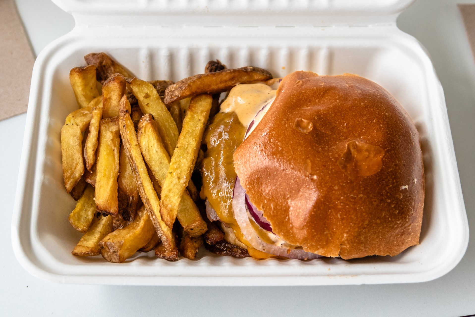 Top view of burger with french fries.